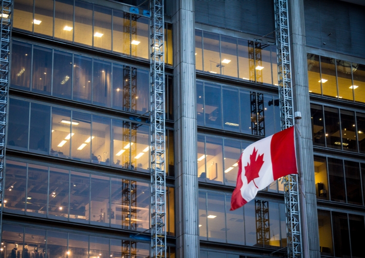 Canadian flag in front of building