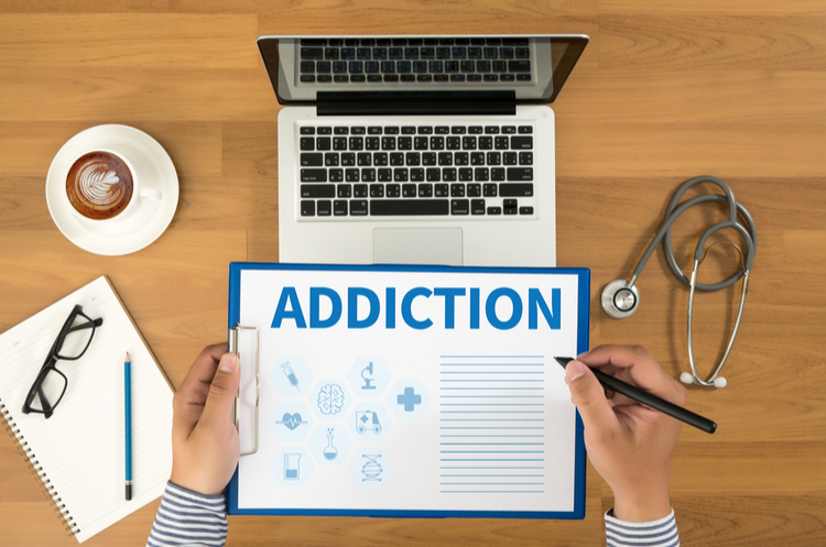 Aerial view of desk with addiction form