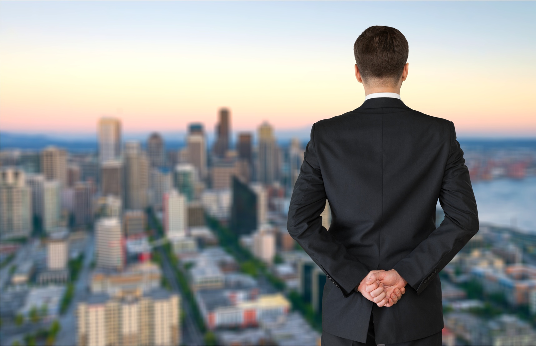 Businessman looking out a window of a skyline