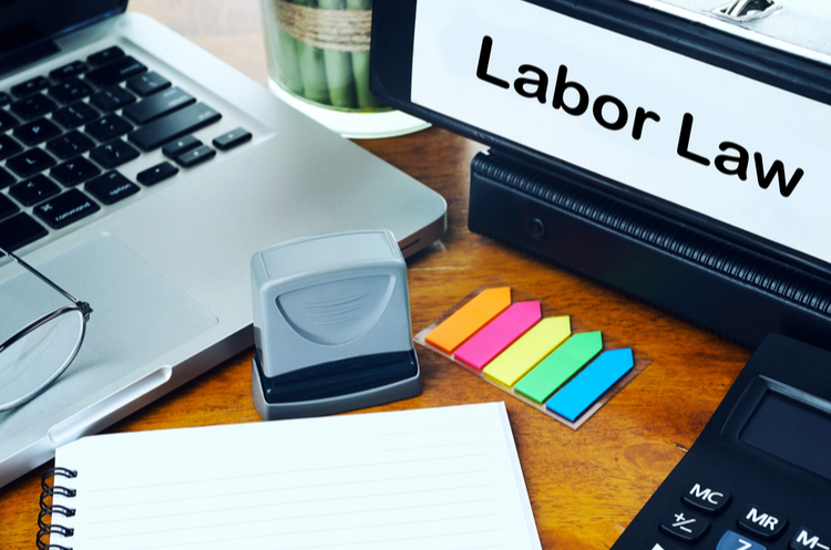 Desk with laptop and labour law binder