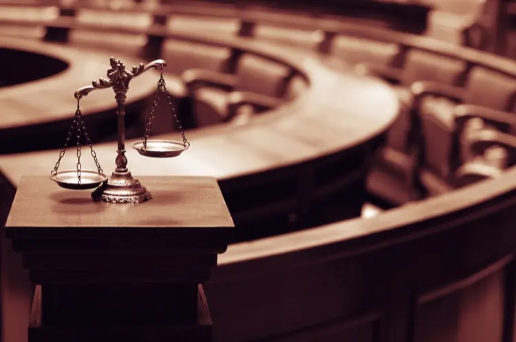 shutterstock_465586604_courtroom and scales of justice_web
