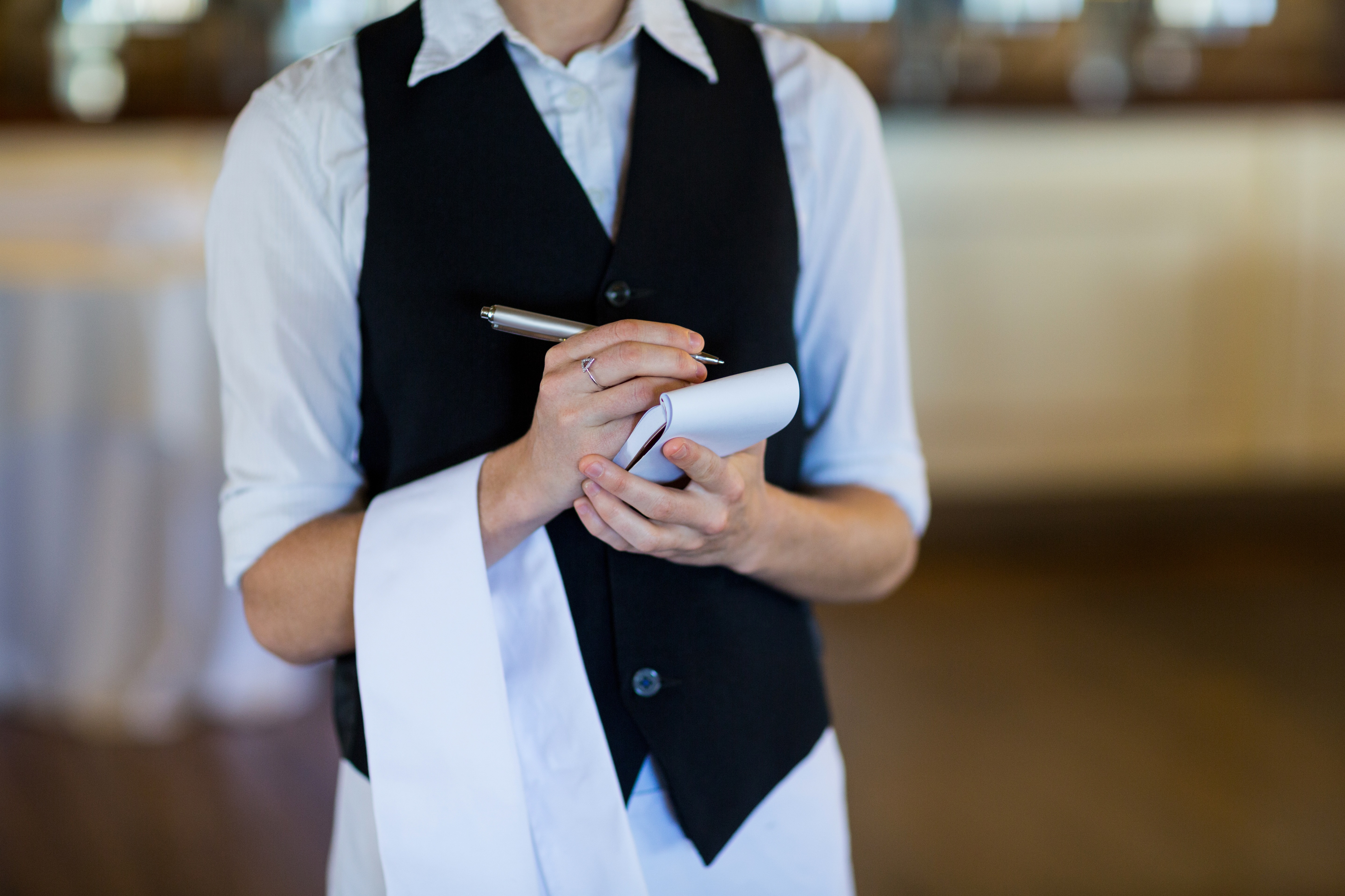 waiter taking an order with a pen on paper