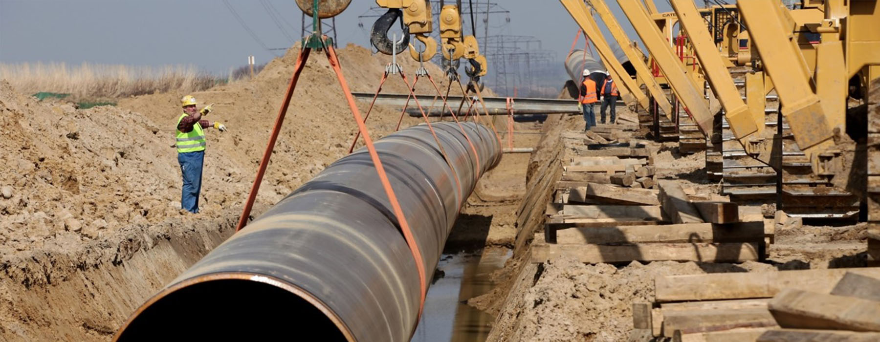 Construction workers laying pipe