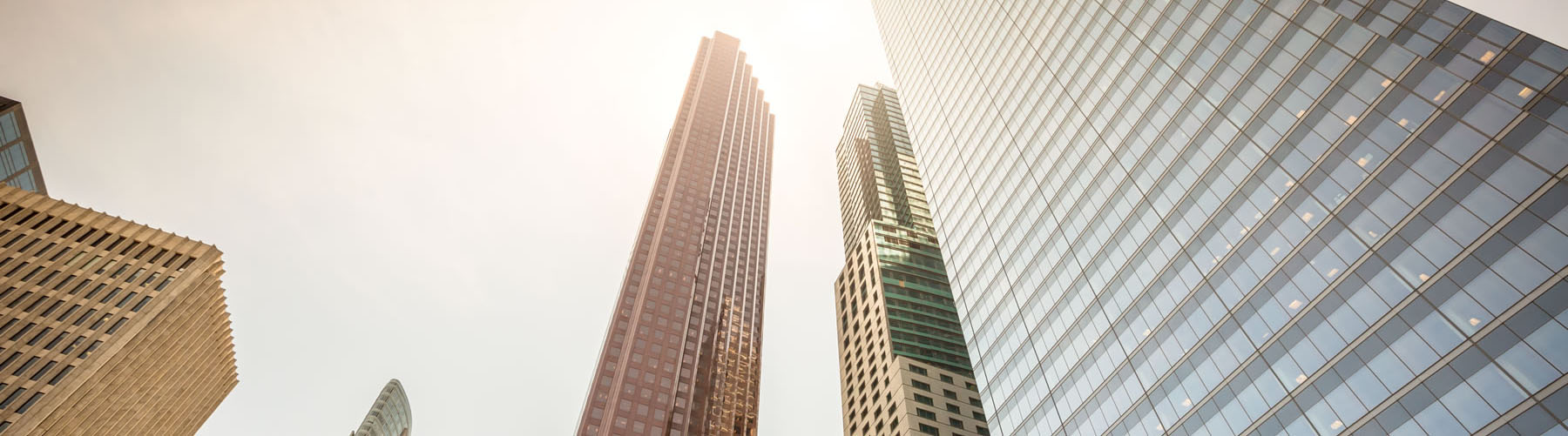 Financial district buildings and skyscraper against the sun